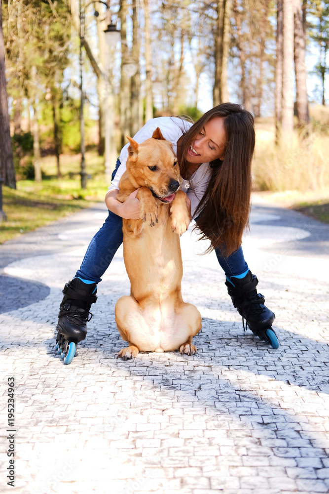 Fototapeta premium Outdoors lifestyle portrait of a beautiful girl wearing roller s