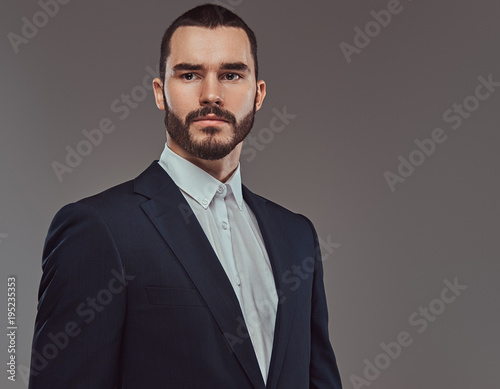 Studio portrait of a brutal bearded businessman wearing a formal