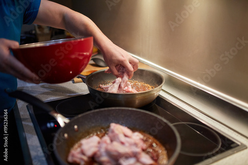 Man cooking chicken wings