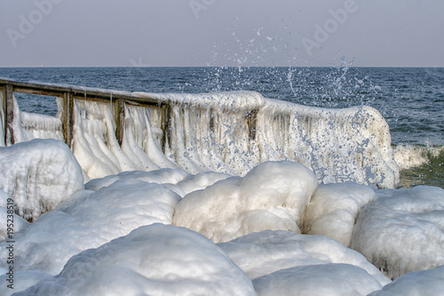 Magic isc sculptures at the beach , on a frosty winter day. - Frozen Ocean ice formations at the Baltic Sea photo