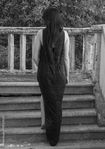 Beautiful young sexy girl with a beautiful figure and long legs. Black white photo. photo