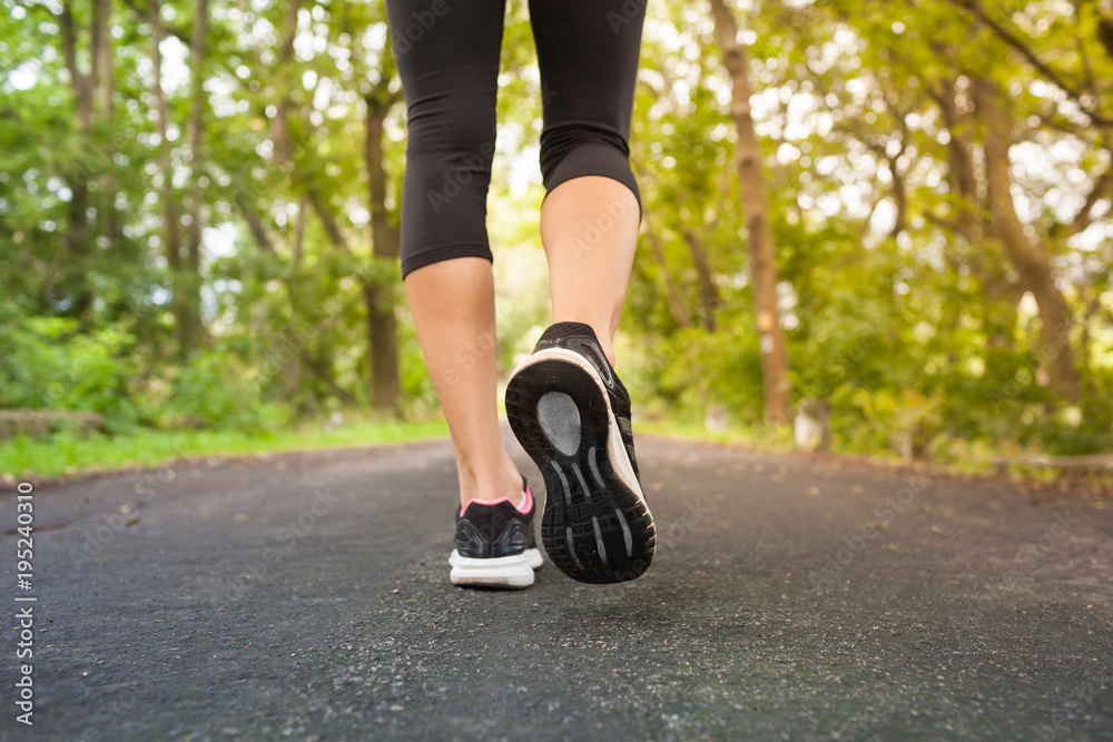 Woman taking a walk on forest trail. Woman taking a walk on forest trail.