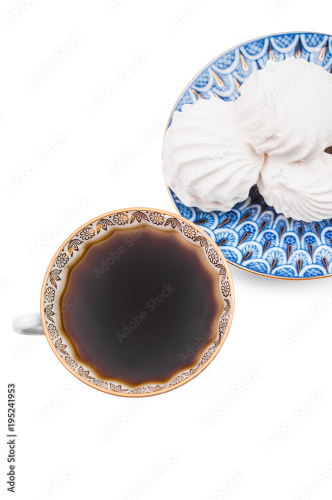 Russian vanilla zephyr on a blue saucer and black coffee in a Cu Russian vanilla zephyr on a blue saucer and black coffee in a Cu