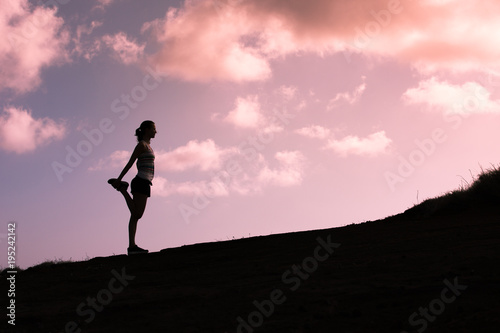 Female runner warming up outdoors. fitness active lifestyle concept. 