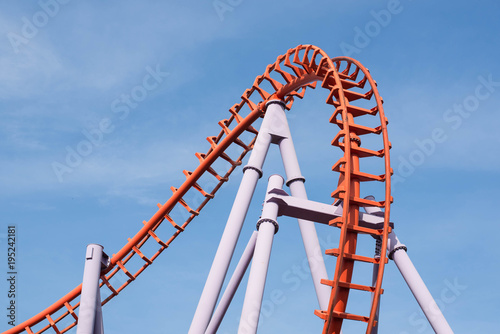 Roller coaster on blue sky background.