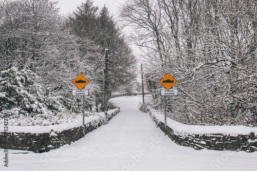 Принти на полотні Irish village during Storm Emma, also known as the Beast from the East, which hit Ireland in the beginning of March: ramps traffic sign