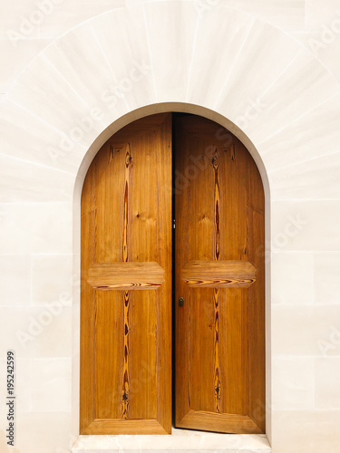 Wooden double door in a stone arch