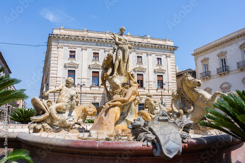 The fountain on the square Archimedes in Siracusa. In the center of the fountain there is a magnificent statue of Diana - hunter, surrounded by sirens and tritons. Sicily