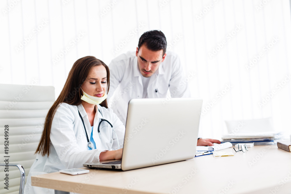 Beautiful nurse explaining report from patient's paperboard Beautiful nurse explaining report from patient's paperboard