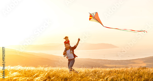 Obraz na plátne happy family father and child daughter run with  kite on meadow.