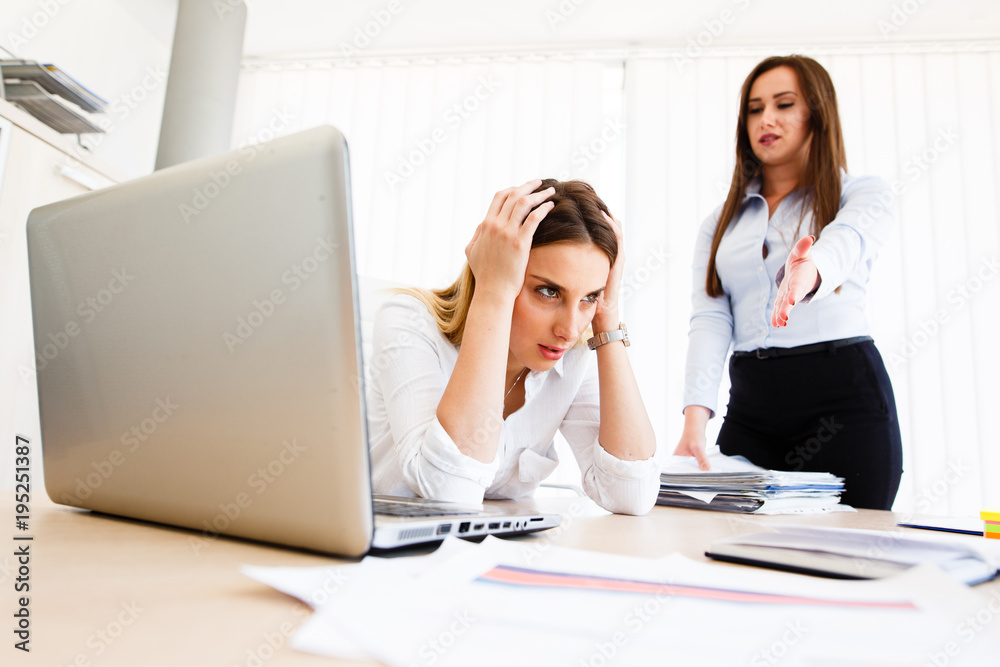 Young female employee has a lot of unsolved tasks Young female employee has a lot of unsolved tasks