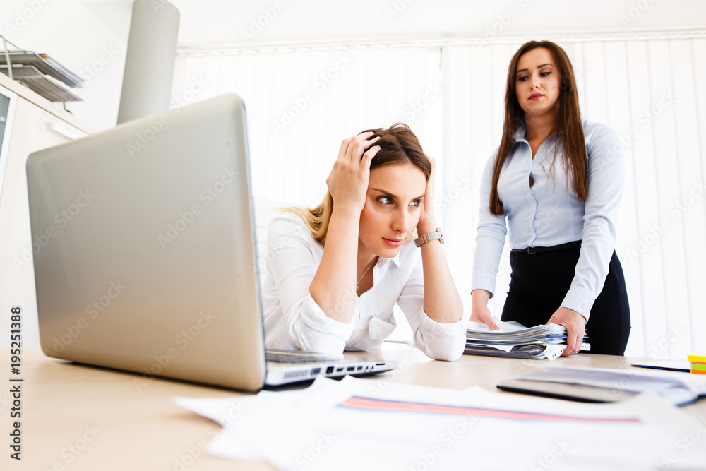 Young female employee has a lot of unsolved tasks Young female employee has a lot of unsolved tasks