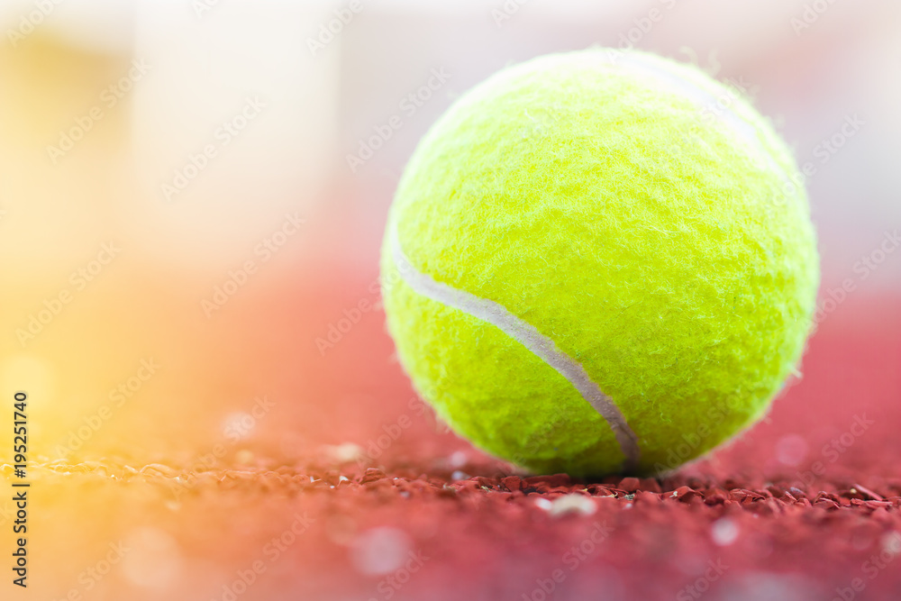 Sport Item concept : Tennis balls at red court in summer day. Tennis is racket sport that can be played individually against single opponent (singles) or between two teams of two players each.