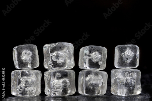 horizontal texture background pile of ice cubes reflection on black, copy space
