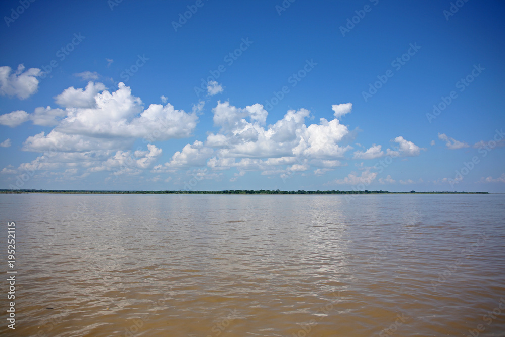 Beautiful reflections of sunny skies on the Irrawaddy River, Myanmar