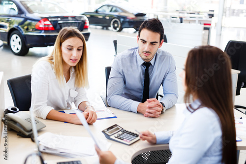 Young couple buying a new car