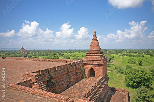 The viewing platform of a red brick temple above the lush green countryside of Burma  in Bagan