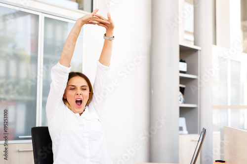 Young tired sleepy female economist 
