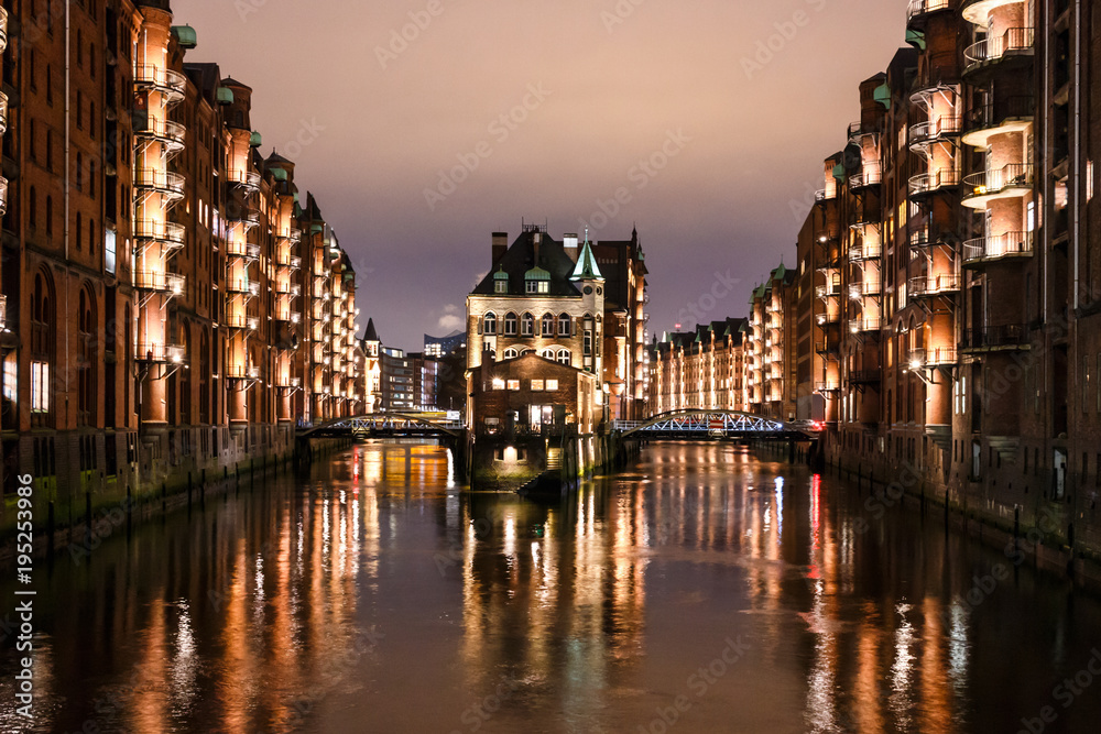 Hamburg Speicherstadt at night, Wasserschloss, buildings with reflection in water