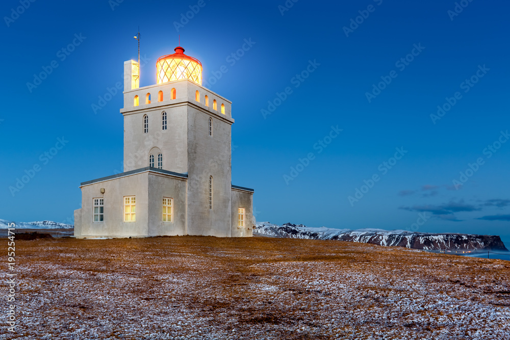 Dyrholaey lighthouse at dusk. The light station at Dyrholaey was established in 1910, near the village Vik, on the southern tip of Iceland.