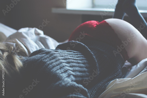 Beautiful naked girl in the grey sweater and red panties.