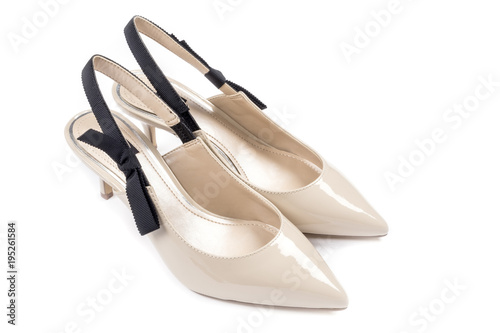 Women's Kitten Heel Dress Shoes in Beige Color Decorated with Black Bow Isolated on White