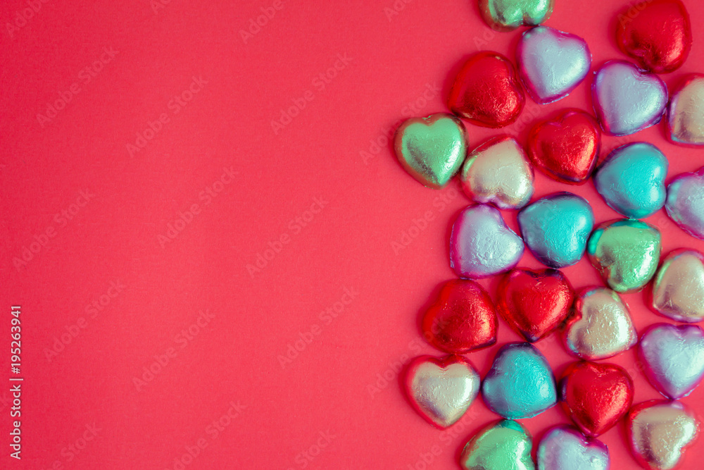 Obraz premium Red background with multicolored heart rests in the concept of Valentine's Day.