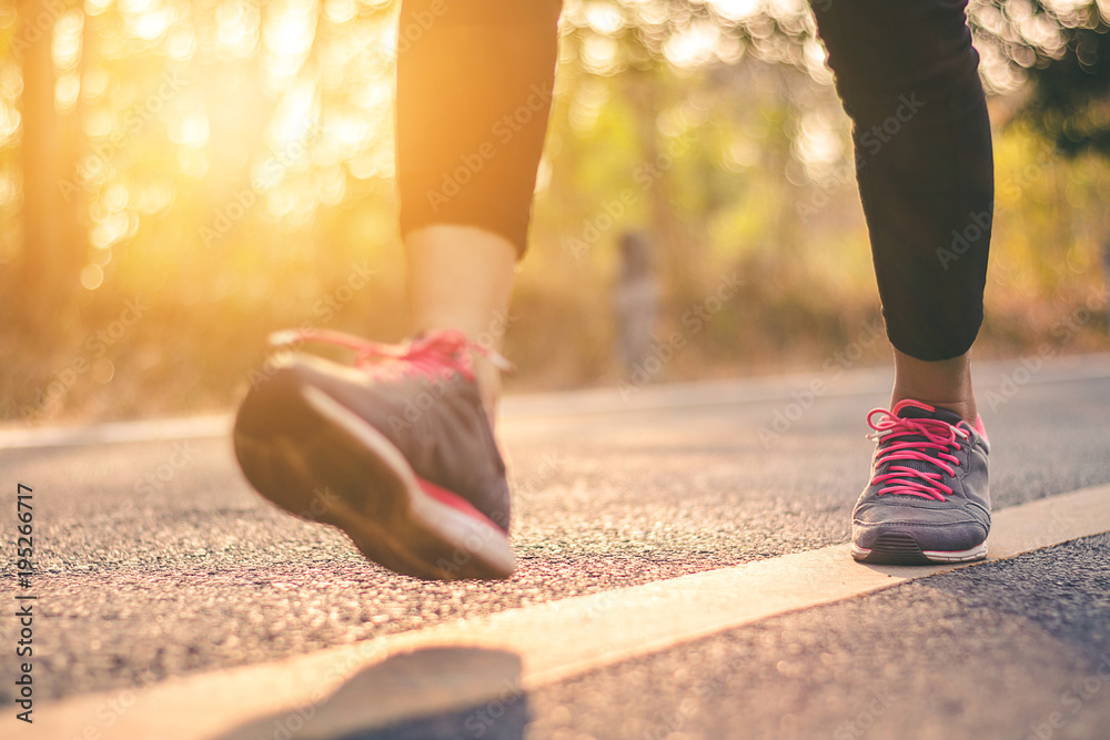 Women runner feet on road in workout wellness concept. Women runner feet on road in workout wellness concept.