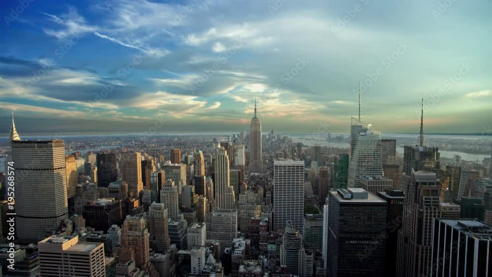 Empire State Building and skyscrapers in Manhattan cityscape from high view - 24 hour time-lapse with seamless loop - New York City NYC in 4K and 1080 HD