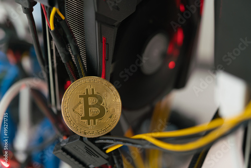 bitcoin on the background of a graphics card in a rack for crypto-currency mining photo