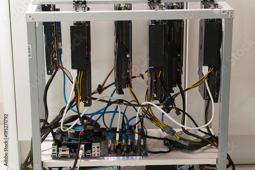 open rack for cryptocurrency mining includes graphics cards, motherboard and hard drive photo