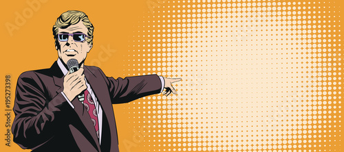 Businessman with microphone points with his finger.