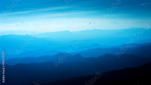 Layers of blue color mountains during sunset , concept of tourism and mountaineering