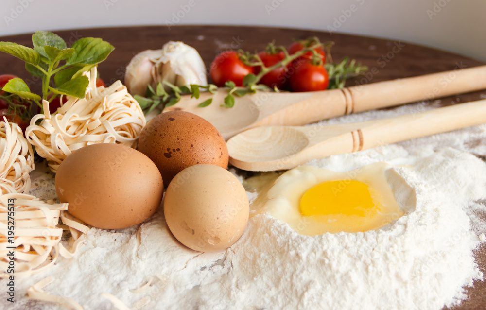 ingredients preparation spaghetti with eggs, tomatoes herbs and spices ingredients preparation spaghetti with eggs, tomatoes herbs and spices