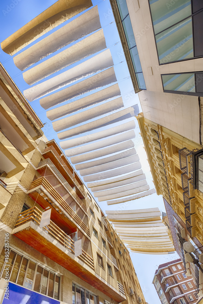 Obraz premium strips of fabric provide protection from the sun in the streets of cordoba spain