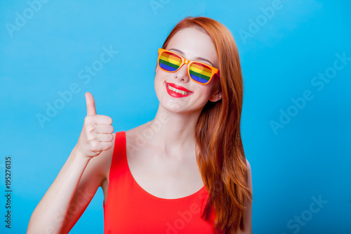 Redhead girl with rainbow sunglasses