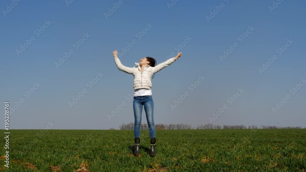 Positive woman jumping in field Positive woman jumping in field