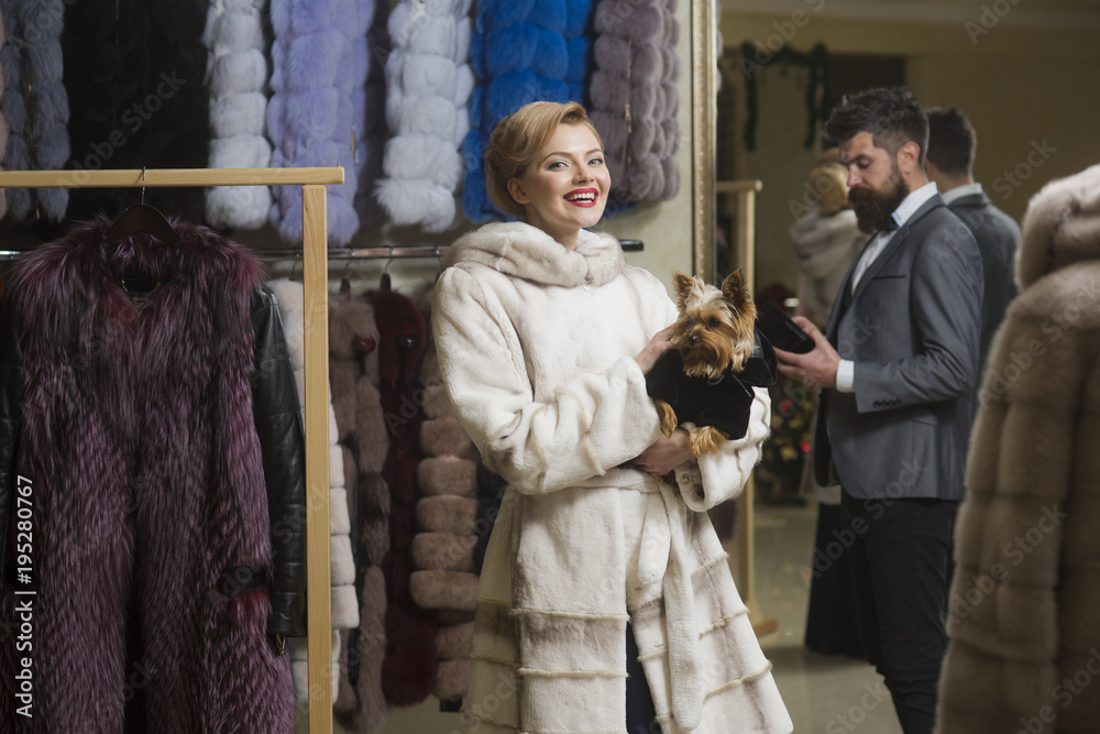 Customer with beard and woman buy furry coat.