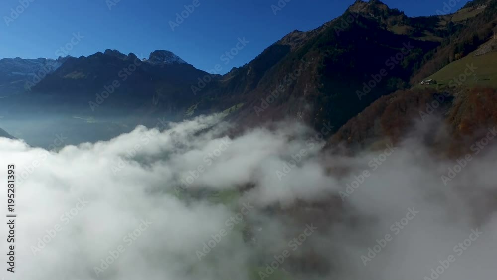 Aerial view in the valley of Engelberg in the foothills of Switzerland on an autumn day with a sea of fog Aerial view in the valley of Engelberg in the foothills of Switzerland on an autumn day with a sea of fog