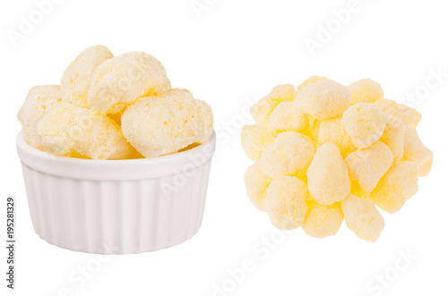 Set of sweet yellow corn sticks with powdered sugar as heap and in ceramics bowl isolated on white background. Fast food template for menu, advertising, cover.