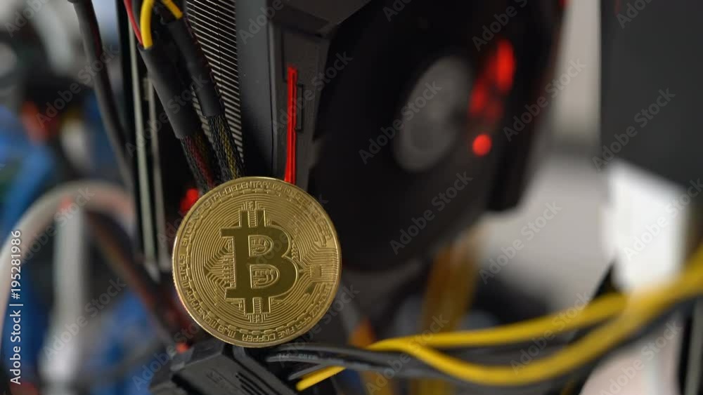 bitcoin on the background of a graphics card in a rack for crypto-currency mining
