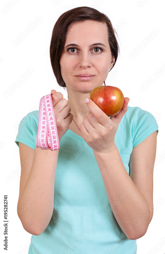 One girl holds before herself apple and meter One girl holds before herself apple and meter