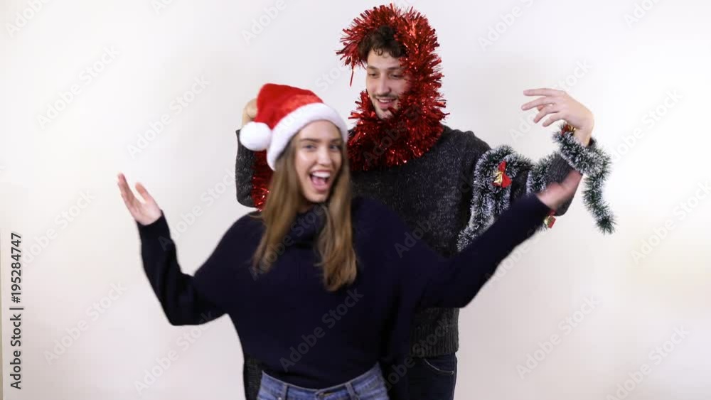 A man and a woman playing with tinsel A man and a woman playing with tinsel