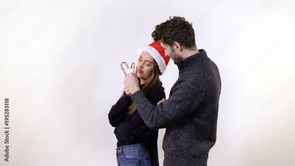 Man and woman playing with candy canes Man and woman playing with candy canes
