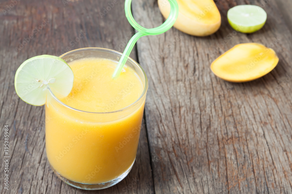 Close up mango smoothie on rustic wooden table, Summer concept Close up mango smoothie on rustic wooden table, Summer concept