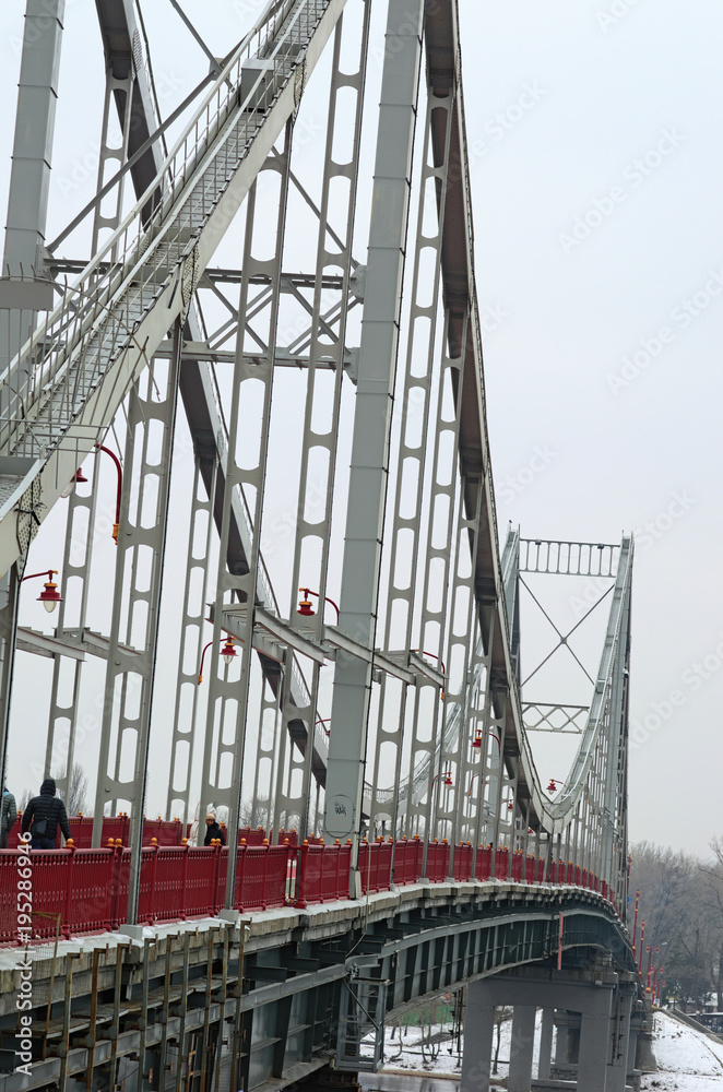 Fototapeta premium Farms metal Pedestrian Bridge in Kyiv, Ukraine. Support above the bridge, steel structure close-up