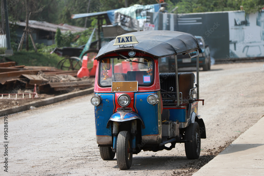 Tuk Tuk is a three-wheeled motorized vehicle used as a taxi, waiting for passengers on the road.