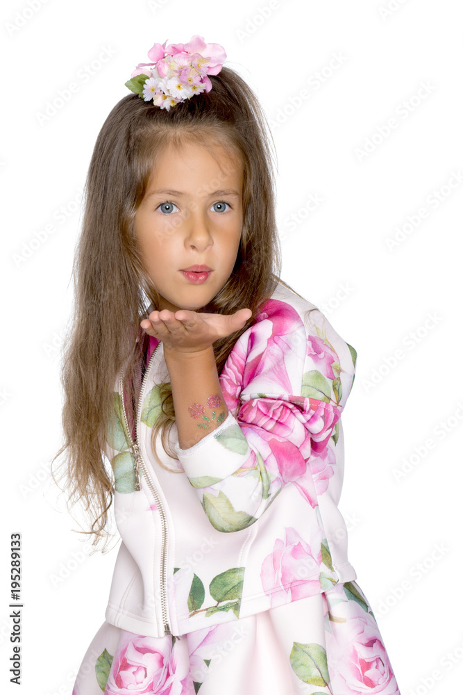 Little girl blowing on the palm