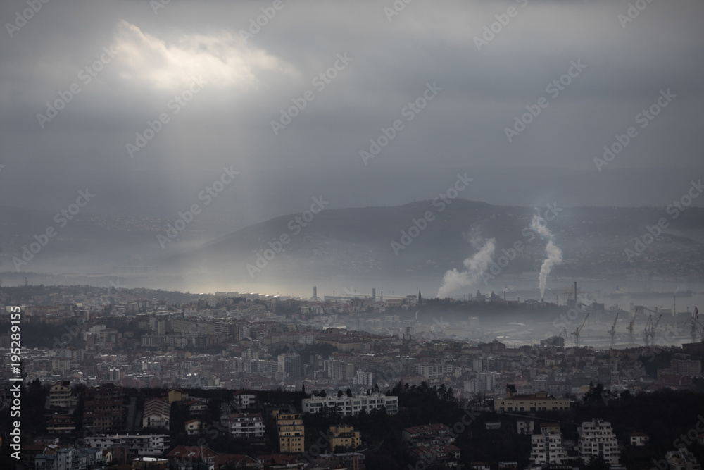 Fototapeta premium Moody and misty morning city and sea landscape in Trieste, Italy 