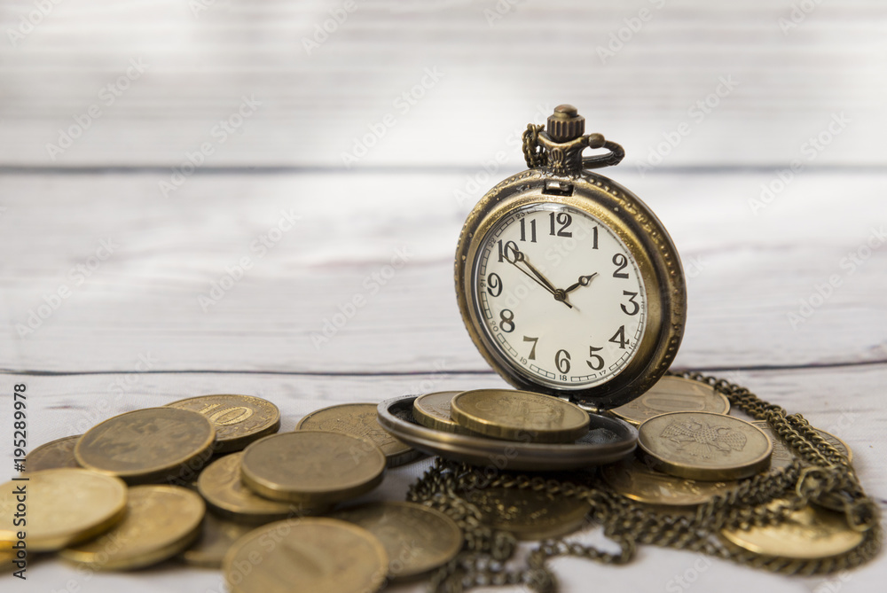 time and money, dial, hands, pocket watch on a large variety of coins time and money, dial, hands, pocket watch on a large variety of coins